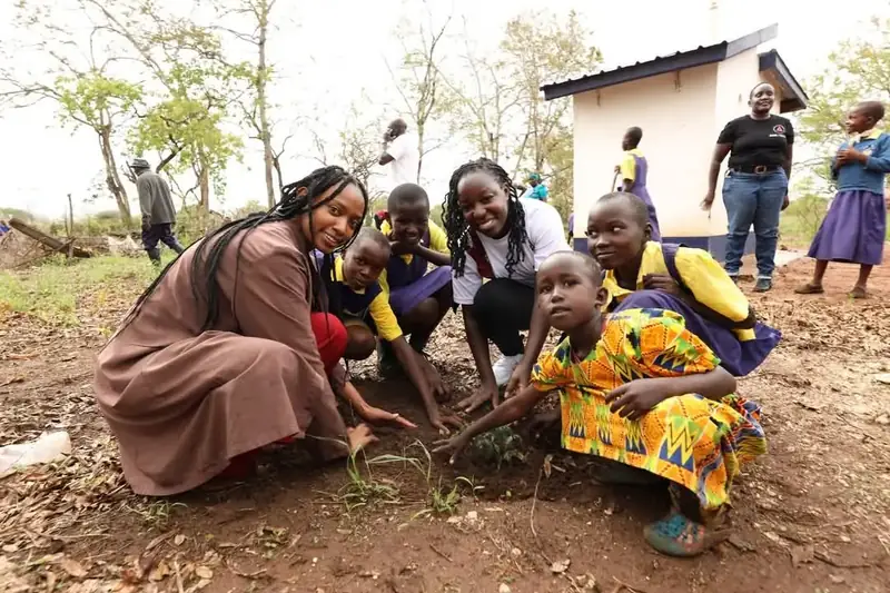 Pupils plant trees with AAK volunteers at Iiani School, Nzambani