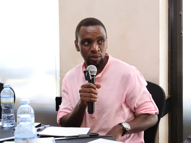 A participant speaks from his table