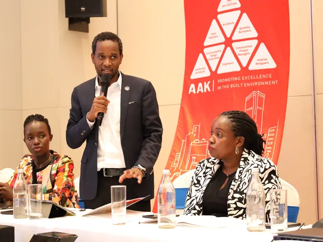 A speaker at the head table beneath the AAK banner