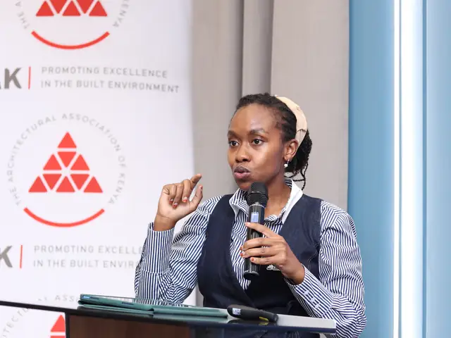 A speaker presents in front of the AAK banner